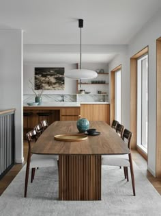 a wooden table with chairs around it in a room