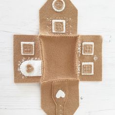 an ornament made out of felt with buttons on the front and back side