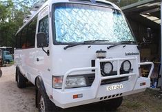 a white van parked in front of a building