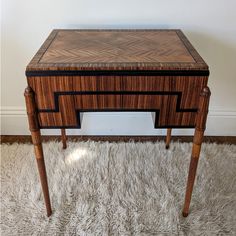 a small wooden table on top of a white rug