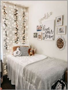 a bedroom decorated with lights and pictures on the wall, including a small child's bed