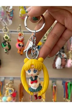 a hand holding a keychain with a cartoon character on it