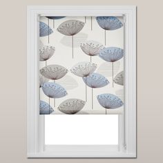 an open window with blue and white flowers on the blind in front of it,