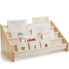 a wooden display with greeting cards and books in it's holder, on a white background