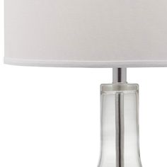 a glass table lamp with a white shade