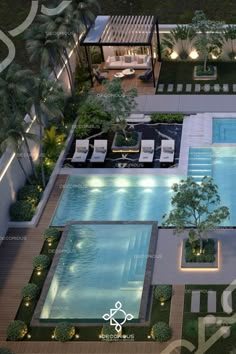 an aerial view of a swimming pool surrounded by greenery and trees at night time