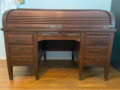 an old wooden desk with drawers on it