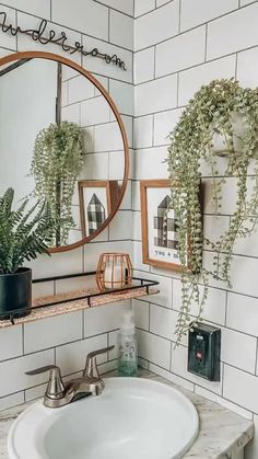 a white sink sitting under a mirror next to a wall mounted faucet in a bathroom