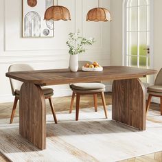 a dining room table with two chairs and a bowl of fruit on the table next to it