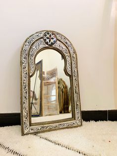 a mirror sitting on top of a white rug