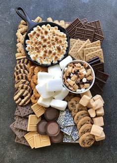 a platter filled with lots of different types of desserts and crackers on top of a table