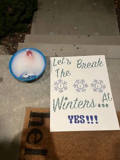 a sign that reads let's break the winters at yes and next to a candle