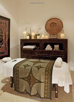 a spa room with towels and candles on the table