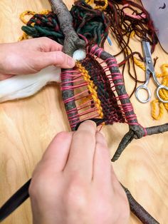 someone is working with yarn and scissors on a piece of fabric that has been made into a bird