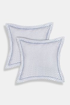 two white pillows with blue dots on them