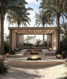 an outdoor seating area surrounded by palm trees and lit up with candles in the middle