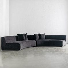 a black and grey couch sitting in front of a white wall