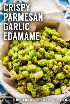 crispy parmesan garlic edamame in a white bowl on a blue tablecloth