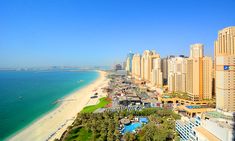 an aerial view of the beach and buildings in abura, united arab emirates region