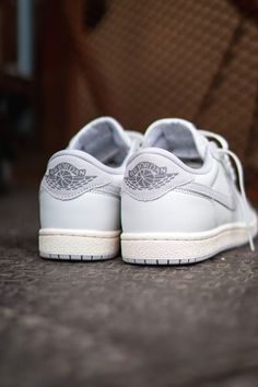 To celebrate the Air Jordan 1's 40th anniversary, Jordan Brand introduces the Air Jordan 1 Low '85 "Neutral Grey." This retro-inspired sneaker features a classic white and grey colour scheme with slightly aged midsoles for a nostalgic touch. The design stays true to the original eight lace holes setup and incorporates larger grey suede Swooshes. Iconic details like the Nike Air logo on the tongue, Jordan Wings on the suede heel panel, and perforated toe boxes remain. A grey concentric rubber outsole completes the look, making it an ideal staple choice. Leather Uppers Rubber Outsole Grey Colour Scheme, Jordan Wings, Air Logo, Air Jordan 1s, Grey Color Scheme, Air Jordan 1 Low, Billionaire Boys Club, Jordan 1 Low, Grey Suede