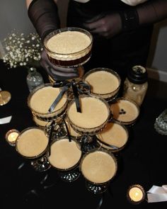 a table topped with lots of glasses filled with liquid