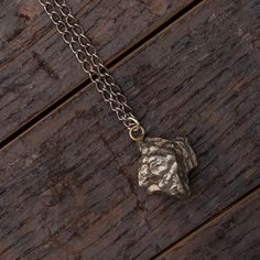 Add a stellar twist to your style with this long meteorite necklace! This men's or women's sterling silver pendant holds a small chunk of the campo del cielo meteorite and is strung on a30" black, gunmetal chain.Our 20" campo meteorite nugget necklace (SIG3040) is a more feminine option; it includes the same pendant strung on a shorter, polished sterling silver chain.In stock and ships within 1-3 days.DETAILS OF THE PENDANT Campo del Cielo Meteorite Metal: Sterling Silver Size: .5 - 1.5 Inches* Gunmetal Sterling Silver Pendant Necklace, Gunmetal Pendant Necklace In Sterling Silver, Gunmetal Hand Forged Necklaces For Gift, Hand Forged Gunmetal Necklaces For Gift, Meteorite Necklace, Meteorite Jewelry, Mens Wedding Bands Unique, Meteorite Pendant, Meteorite Ring