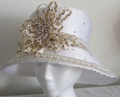 Women's White Top Hat with White and gold loops. Pearls going around the trim, rhinestones on the crown. Size: Handmade Gold Hat For Kentucky Derby, Elegant Handmade Hat Bands For Summer, Handmade Formal Hats, Elegant Gold Hat Bands For Summer, Gold Curved Brim Hat Band For Party, Gold Hat Band For Party With Curved Brim, Gold Wide Brim Costume Hat For Parties, Handmade Elegant Wide Brim Hat Bands, Gold Curved Brim Hat For Kentucky Derby