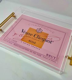 a glass plaque that has been placed on top of a white table with gold handles