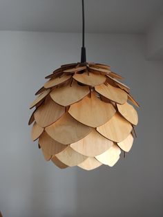 a wooden light fixture hanging from a ceiling