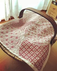 a chair with a red and white quilt on it