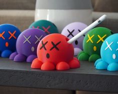 a group of colorfully decorated toys sitting on top of a table