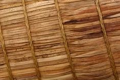 close up view of the top of a bamboo roof with vertical lines and horizontal stripes