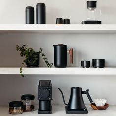 the shelves are filled with different types of coffee pots, cups and tea kettles