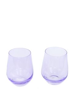 two purple glasses sitting next to each other on a white surface with no one in it