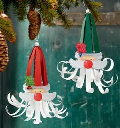 two christmas ornaments hanging from a tree