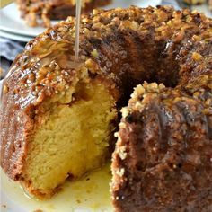 a bundt cake with one slice cut out and ready to be eaten by someone