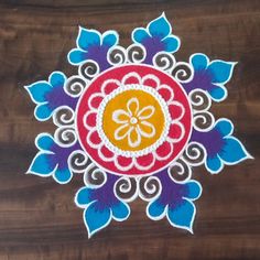 an intricately decorated wooden surface with blue, yellow and red designs