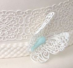 a white lace with a blue butterfly on it