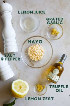 ingredients to make lemonade are shown on a counter top, including mayonnaise, salt, pepper, and lemon zest