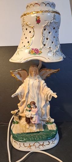 an angel figurine on top of a lamp shade