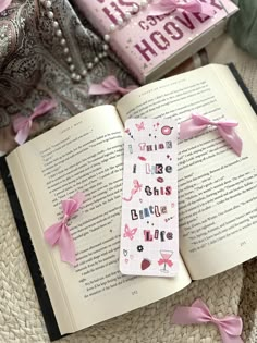 an open book with pink bows on it