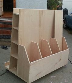 a wooden shelf with six compartments on the bottom and one section open to show it's contents