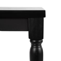 a close up of a black table with a white back drop down on the top