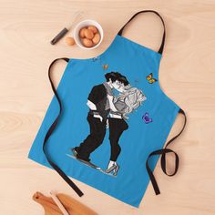 a blue apron with an image of two people kissing on the front and one holding a cup