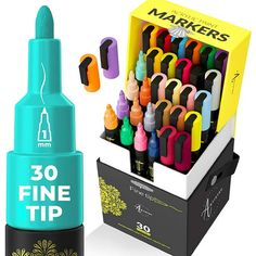 the marker pens are in a box and next to it's holder with markers