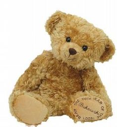 a brown teddy bear sitting next to the words i still sleep with a stuffed animal