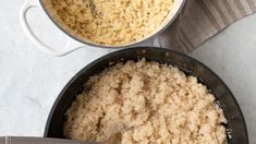 two pans filled with rice on top of a table