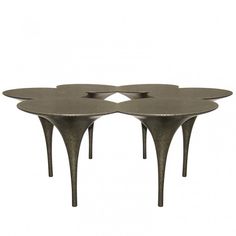 three metal flower shaped tables sitting on top of each other