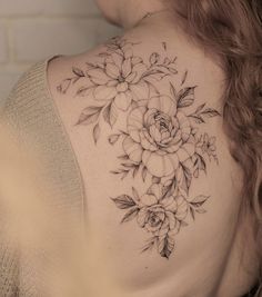 a woman with a flower tattoo on her back