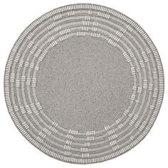 a round rug made out of woven material with white and grey lines on the center